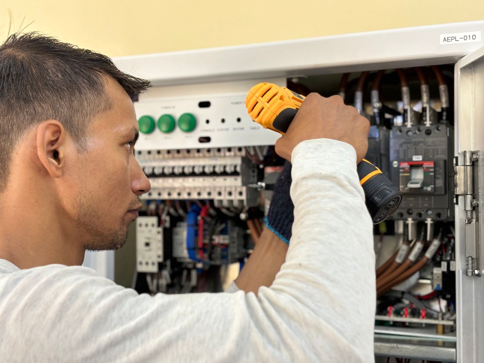Professional electrician working on an electrical panel